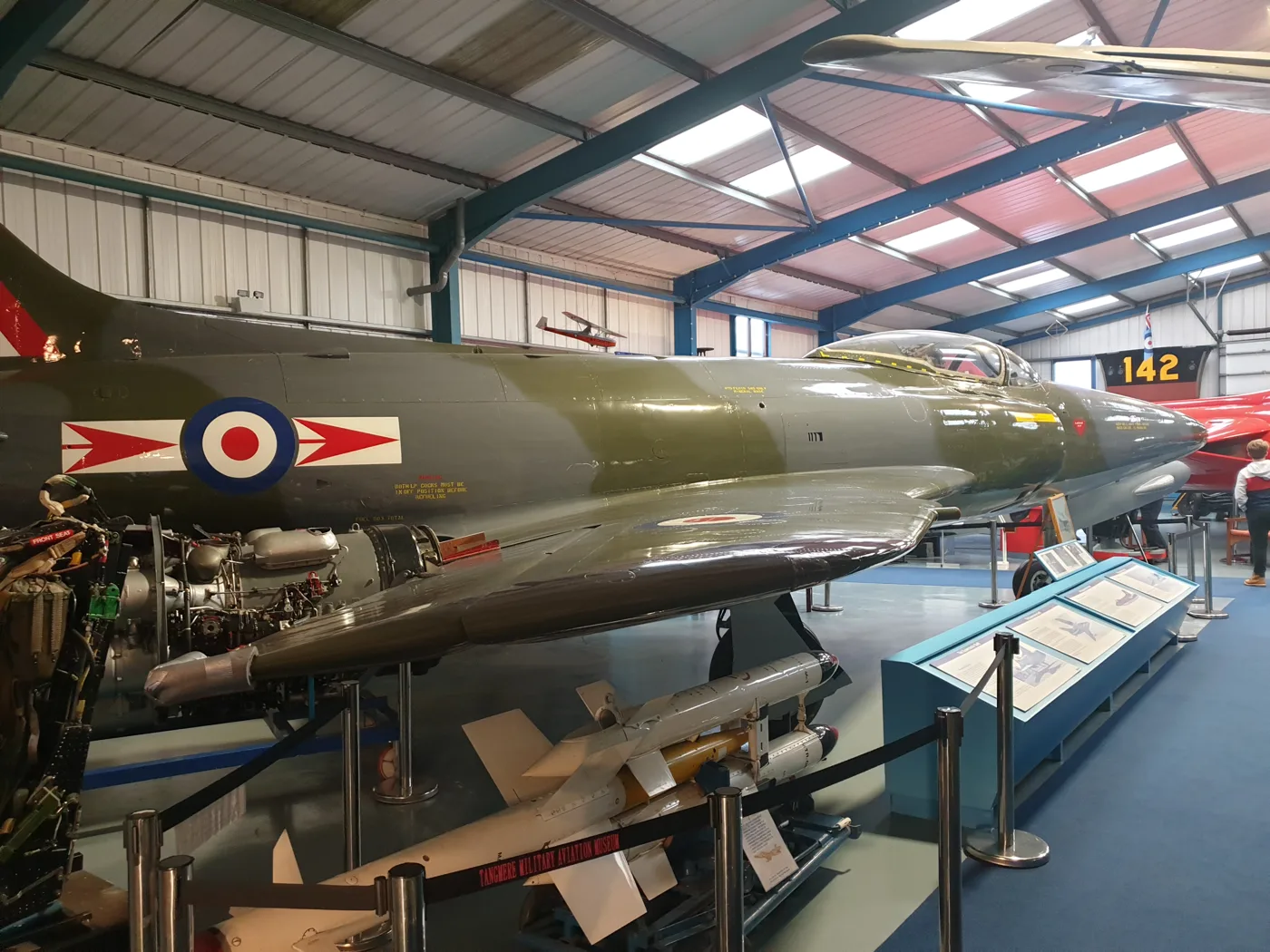 A jet fighter in RAF markings on display inside the hangar at Tangmere Military Aviation Museum